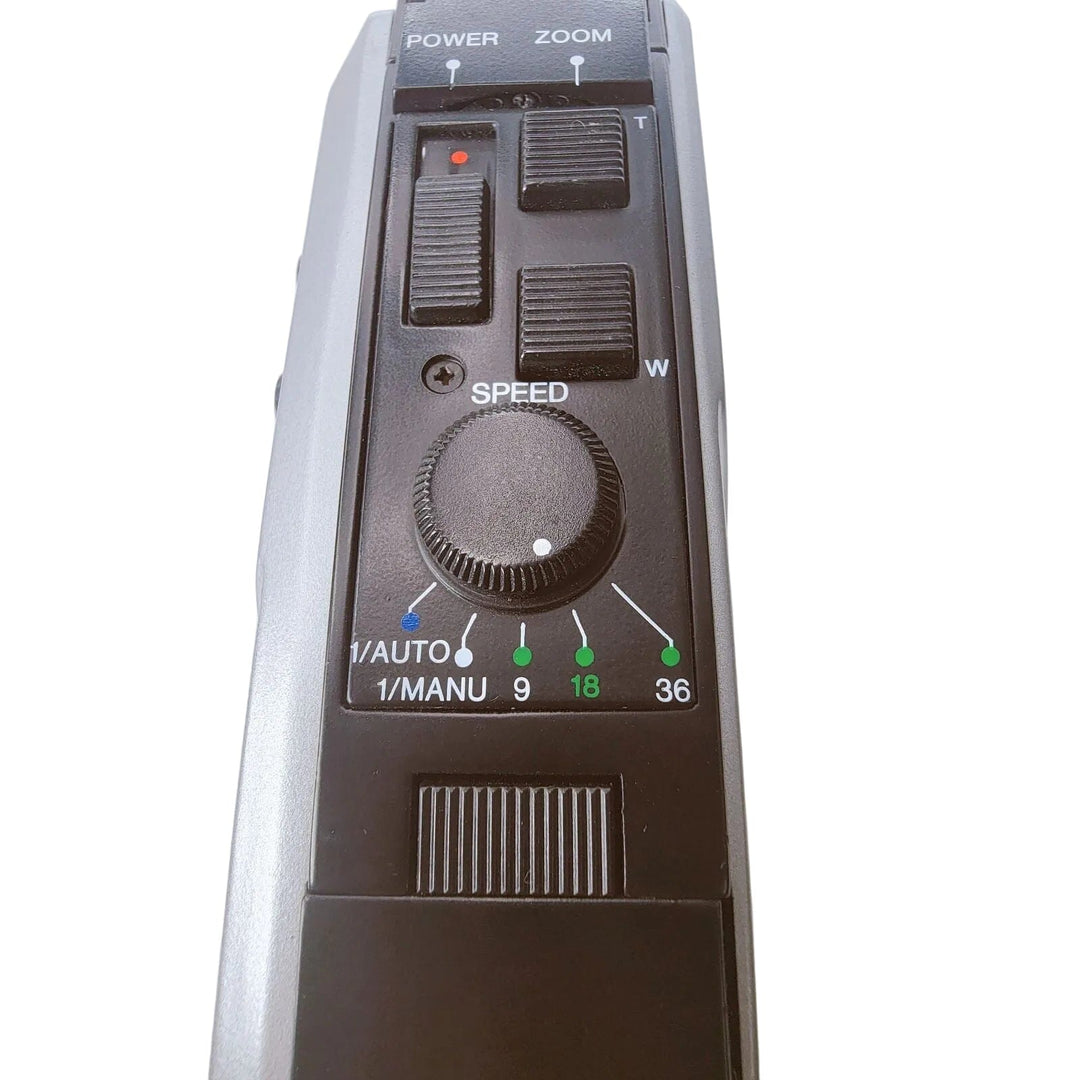 Close-up of a Bauer C107XL camera zoom lens speed control dial with power and zoom buttons above, and speed settings from 1/Auto to 36 on a light gray background.