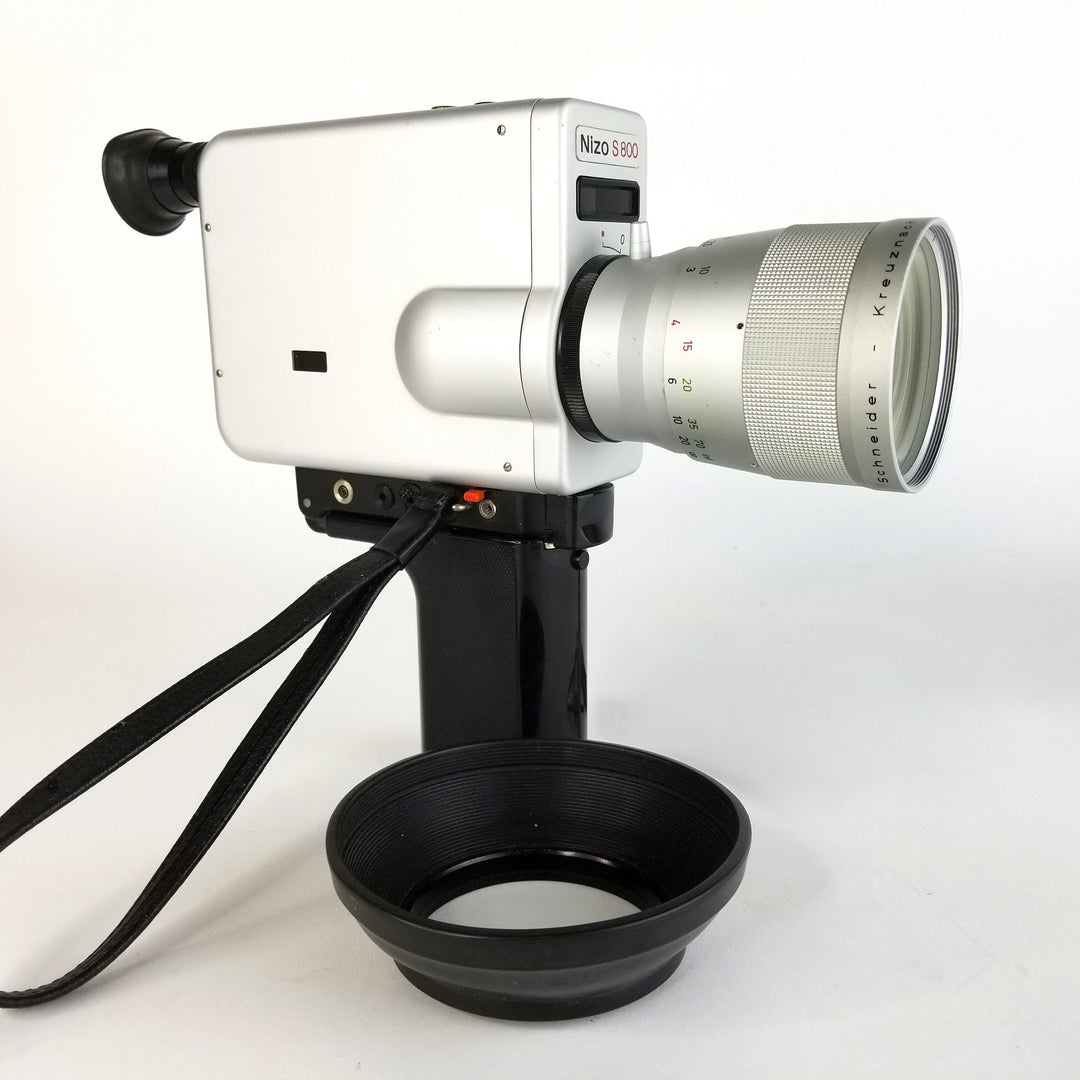 Side view of the Nizo S800 Super 8 movie camera, showing its body, handgrip, and vintage camera design. Professionally Serviced by MonsterFlipsUSA