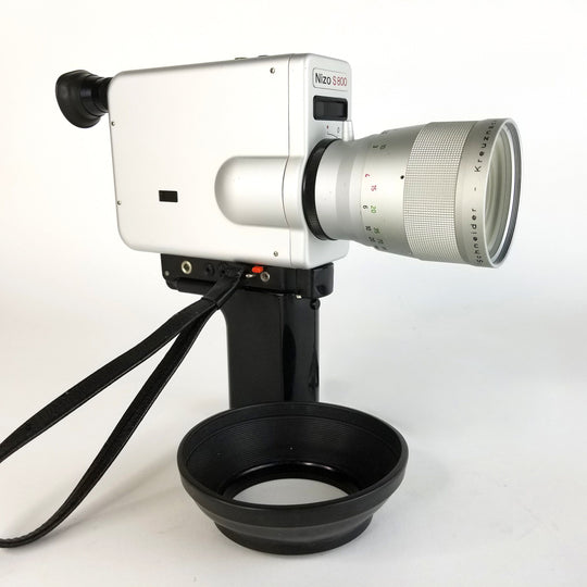 Side view of the Nizo S800 Super 8 movie camera, showing its body, handgrip, and vintage camera design. Professionally Serviced by MonsterFlipsUSA