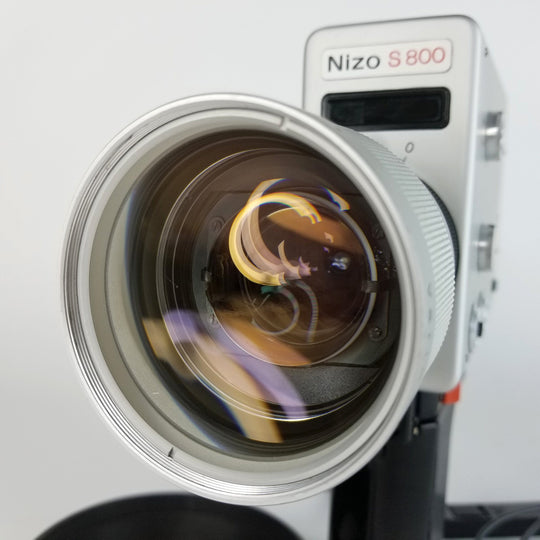 Close up of a Nizo S800 front lens, professionally serviced by MonsterFlipsUSA